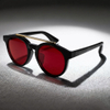 Sophisticated Round Double-Bridge Sunglasses with Transparent Frames and Red Lenses