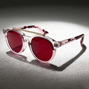 Sophisticated Round Double-Bridge Sunglasses with Transparent Frames and Red Lenses